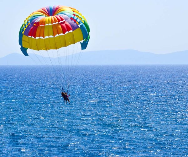 Tourists parasailing on aegean sea in Kusadasi, Turkey